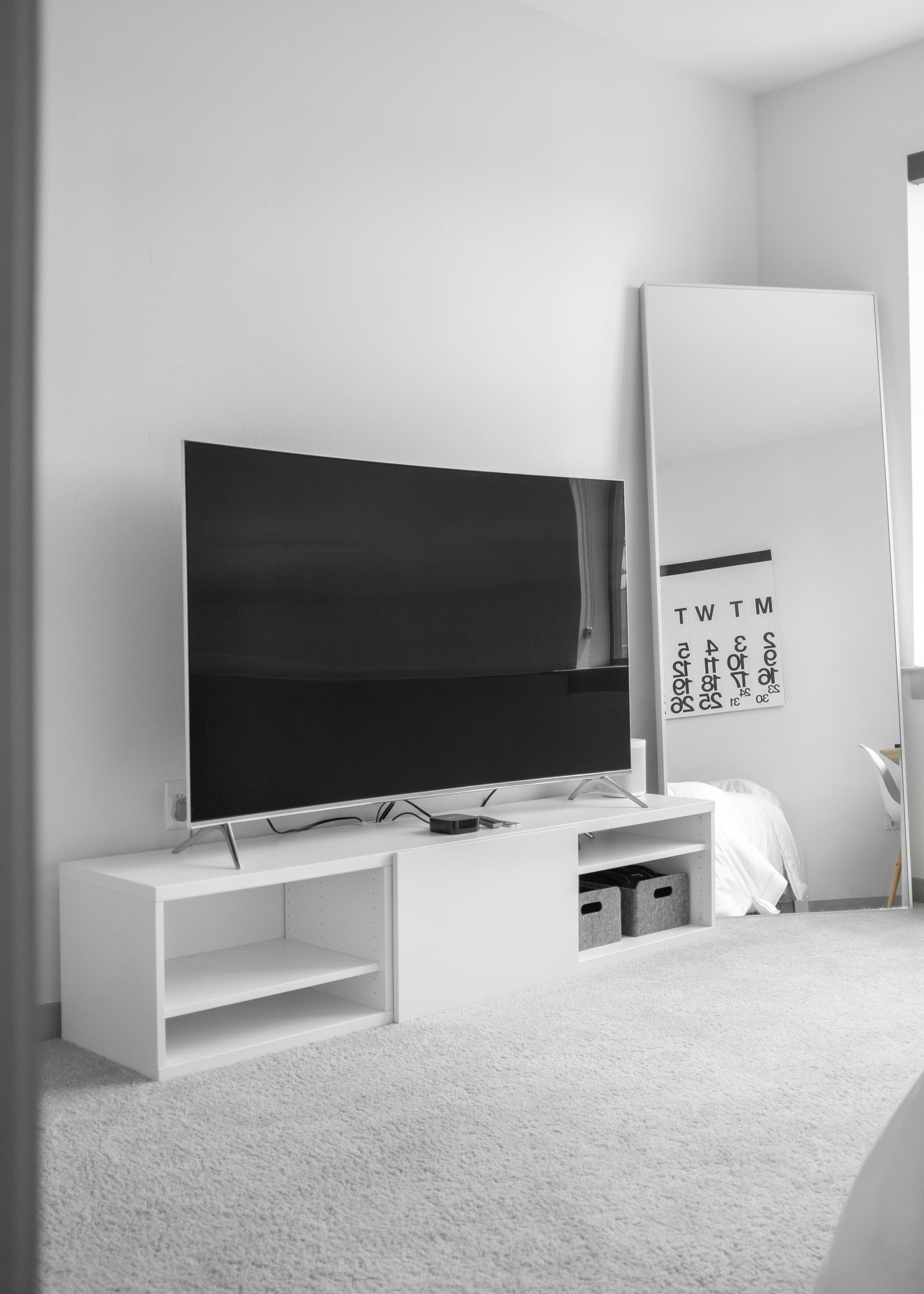 Modern flat-screen smart TV mounted on wall displaying streaming content