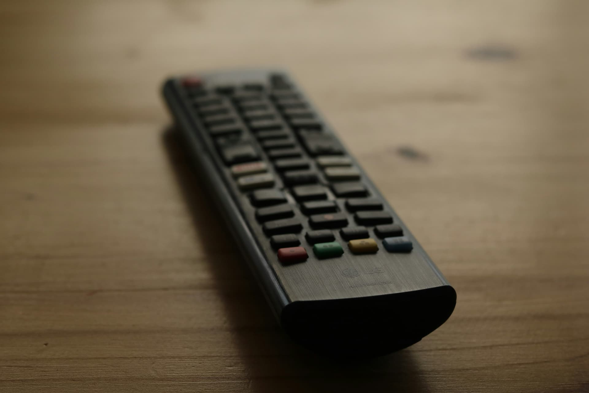 LG television remote control on a wooden table