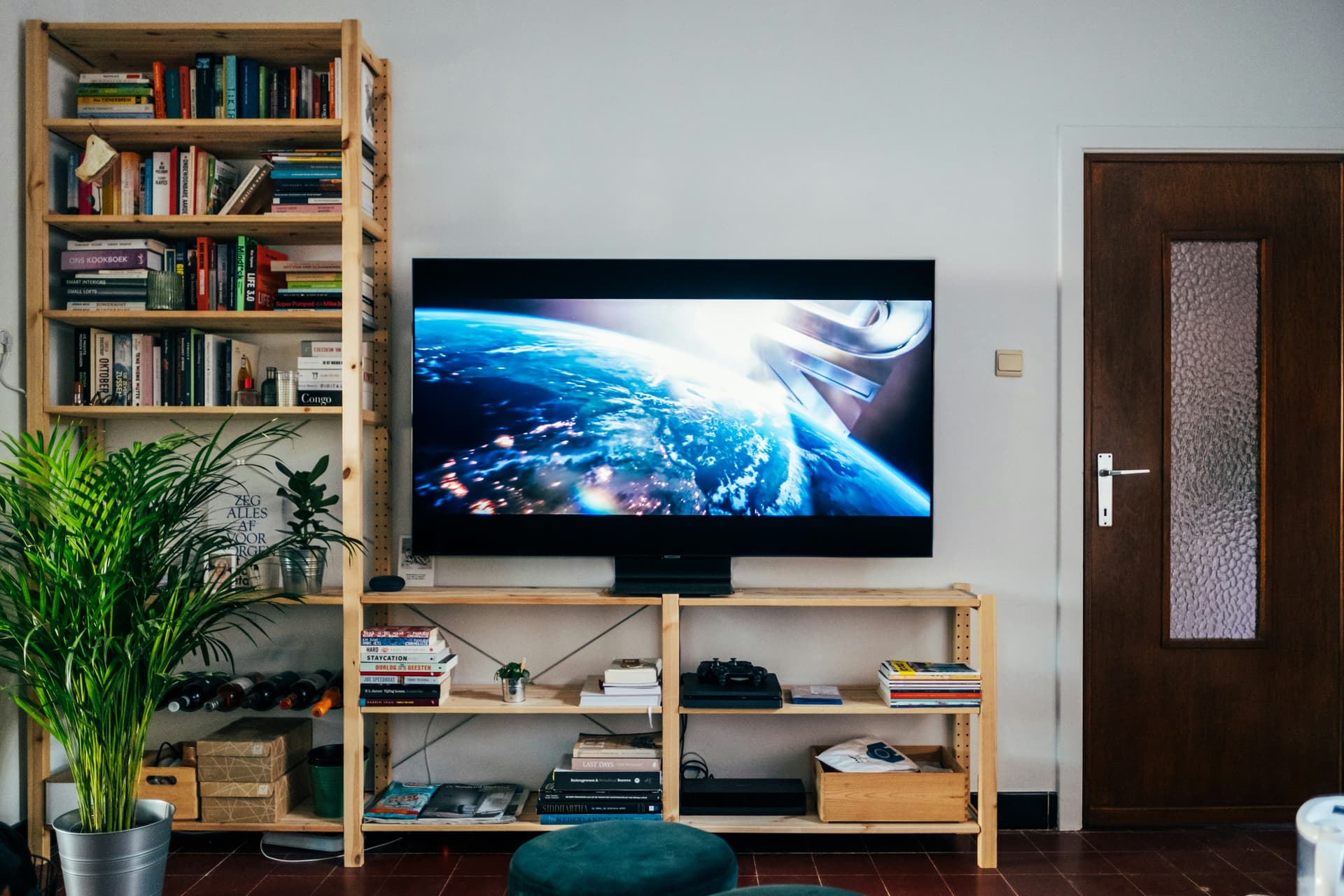 Smart TV set up on a wooden shelf unit in a home living room